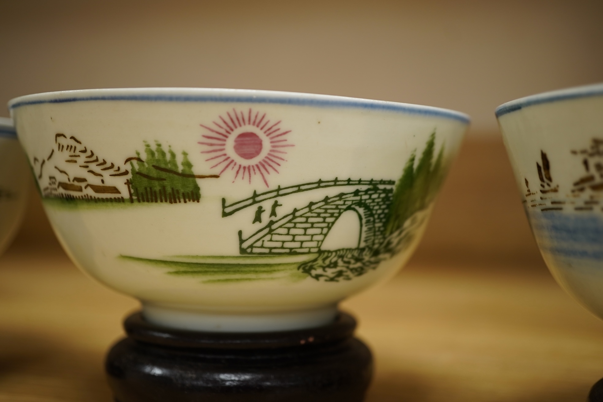 A Chinese Cultural Revolution porcelain teapot, six bowls, wood stands and an enamel tray-29.5cm diameter. (8)